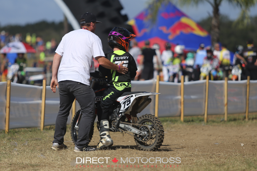 Timmy Ferry gives his son, Evan, a pat on the back after a moto. 